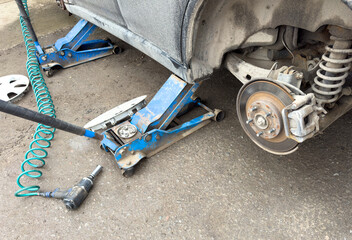 A car is being lifted up by a jack