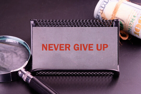 Naklejki Business development challenge concept and effort success idea. Never give up written close-up on a gray business card