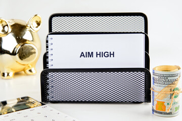 Aim High symbol. Business and Aim High concept. AIM HIGH words on a blank sheet of notepad, a...
