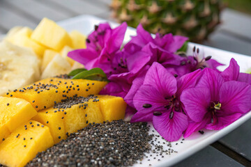 Closeup Vibrant Purple Flowers and Tropical Fruits with Chia Seeds