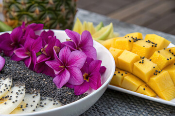 Closeup Vibrant Purple Flowers and Tropical Fruits with Chia Seeds