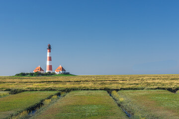 View of the salt marshes and tidal creeks towards the Westerheversand lighthouse, Westerhever, Eiderstedt, North Frisia, Schleswig-Holstein, Germany