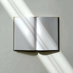 Open book on a white background with sun rays across pages, minimalistic top view