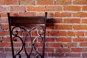 Metal and Wood Chair Back with Brick Wall