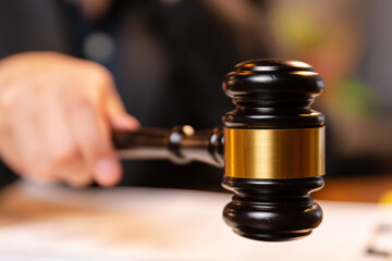 In the office, the professional lawyer laid documents on the table, seeking approval through cooperation to prove innocence before the judge raised the hammer in court.