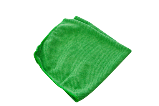 A folded green microfiber cleaning cloth isolated on a black background in a studio setting