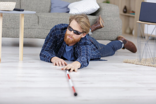 young blind man falling on the floor
