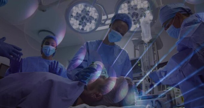 Nurse raising hands initiating light overlay, team managing mask and IV for anesthesia induction