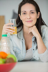 beautiful young woman with glass of orange juice