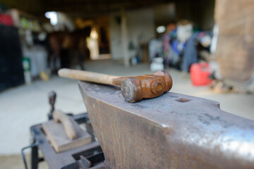 close up of hammer on anvil