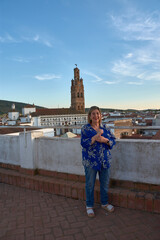 Fototapeta premium Tourist portrait of a woman in Llerena with a monumental background