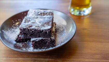 Stack of Brownies with Powdered Sugar on a Plate