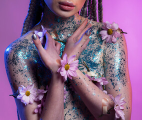 Woman body parts with  medical plaster holds flowers. Closeup face of young beautiful woman with a healthy  skin. Body care and health concept