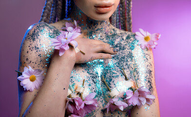 Woman body parts with  medical plaster holds flowers. Closeup face of young beautiful woman with a healthy  skin. Body care and health concept