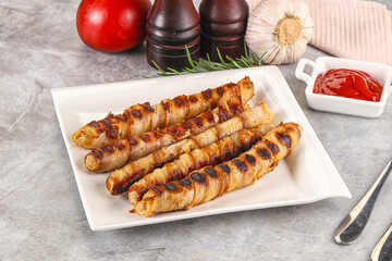 Grilled meat sausages wrapped bacon