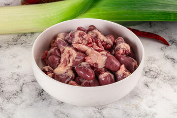 Raw chicken hearts in the bowl