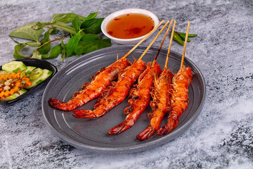 Grilled prawn skewer served sauce