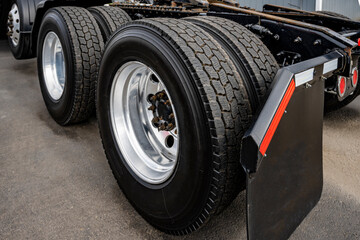Big Rig Semi Truck drive axles with twin wheels and large tread tires for better traction on the road surface