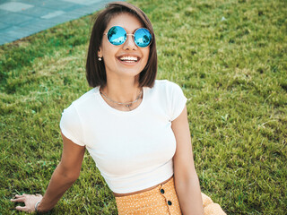 Portrait of beautiful smiling brunette model dressed in summer hipster  clothes. Trendy female...