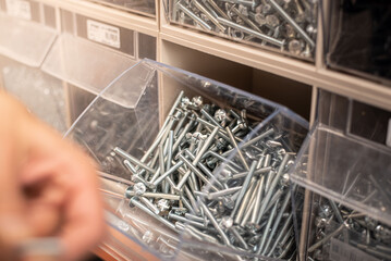 High-resolution macro image of metal screws arranged by size and type. Ideal for showcasing home improvement supplies.