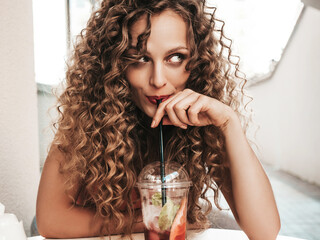 Young beautiful smiling hipster woman with afro curls hairstyle. Woman in summer trendy clothes...