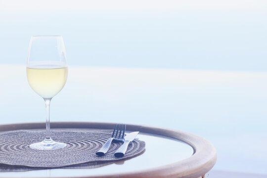 a glass of cold white wine and serving in the restaurant