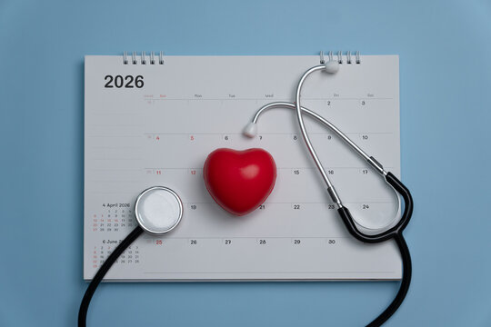 Medical, health care calendar, reminder, schedule or appointment in 2026 concept. Red heart and doctor's stethoscope with calendar on blue background. health checkup.Time management. copy space.
