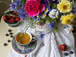 Still life with bouquet of flowers on a tea table