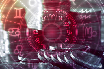 Astrology, horoscope and business concept. Close up of coins to stack  with signs of zodiac over dark background.