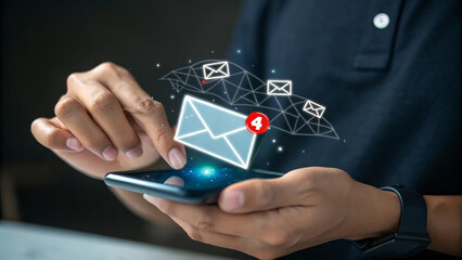 Person holding smartphone with glowing digital interface, The screen displays a prominent email icon, New email notification alert concept