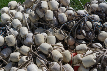 pile of dirty white fishing net floats tangled with ropes, close-up, concept of commercial fishing, marine industry, sustainable seafood