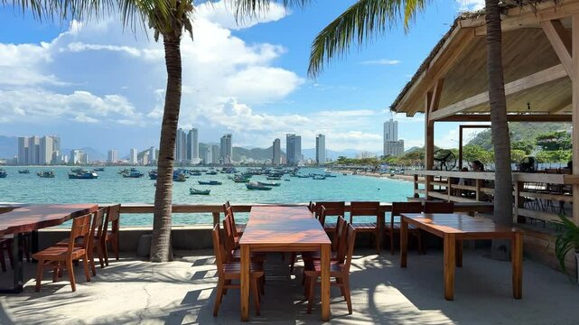 Vietnam, Nha Trang - 3.06.2025 - A reserved table at a beachside cafe. Panorama of the city, ocean view, very nice decor, relaxing on the beach. Rich vacation