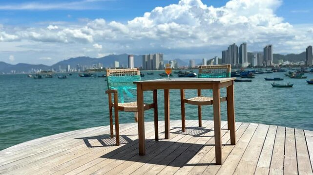 Vietnam, Nha Trang - 3.06.2025 - A reserved table at a beachside cafe. Panorama of the city, ocean view, very nice decor, relaxing on the beach. Rich vacation