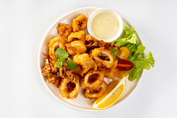 Fried Calamari: Tender calamari rings coated in seasoned batter, deep-fried to crispy perfection, served with marinara or aioli for dipping.