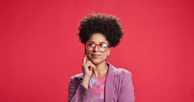 Afro, smile and thinking with black woman on red background for brainstorming, idea or solution. Face, glasses and planning with happy African person in studio space for contemplation or vision