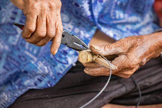 Cutting wire to secure handmade Thai broom