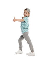 Happy little boy in baseball hat dancing on white background
