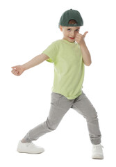Happy little boy in baseball hat dancing on white background
