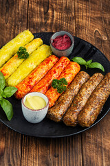Raw grilled sausages and ingredients cooking.