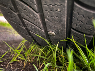 Car Tire Punctured by Metal Screw