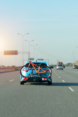 Car with mountain bikes driving on highway