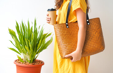Woman holding  bamboo woven bag on white background. Handmade weave bag. Reusable shopping bag. Natural material. Zero waste. Plastic free. Eco friendly concept.