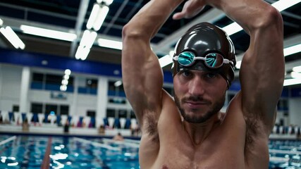 Competitive swimmer prepares for a training session at a local indoor pool in the evening