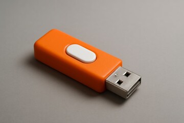 Close-up of Orange Flash Drive on Gray Surface
