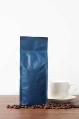 Blue blank coffee bag on wooden table. Packaging mockup with empty space for you designs.