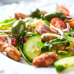 Healthy Salad with Chicken Briest, Cherry Tomatoes, Cucumber, Rocket and Green Olives. Close up.	