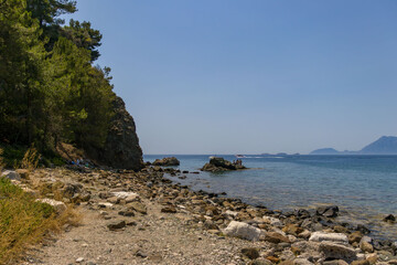 Obraz premium Phaselis harbour. Phaselis beach and Bey Mountains on the background in Antalya Turkey. Beaches of Turkey. 