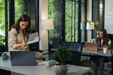 Young businesswomen working in modern office with plants