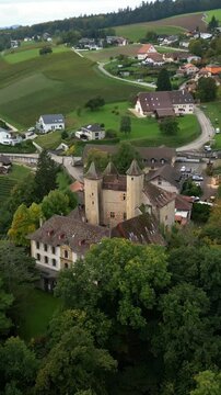 Vertical, aerial: dolly in drone shot of Vaumarcus Castle during the day in canton of Neuchatel, Switzerland