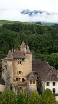 Vertical, aerial: Vaumarcus Castle during the day in canton of Neuchatel, Switzerland, crane up drone shot